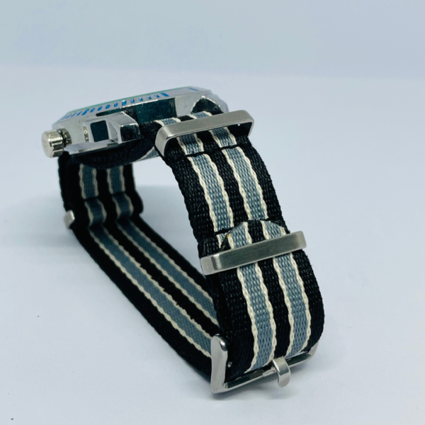 Close-up of black analog watch with striped NATO watch strap