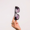 Stylish women wearing oversized sunglasses in sunlight