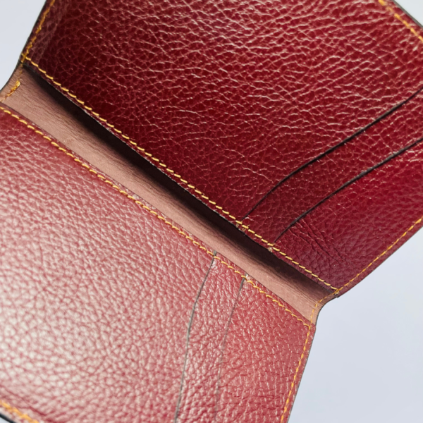 minimalist-wallet-product.jpg Maroon leather wallet with gold stitching