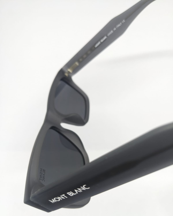 Close-up of dark smoke grey flat tinted lens on square sunglasses