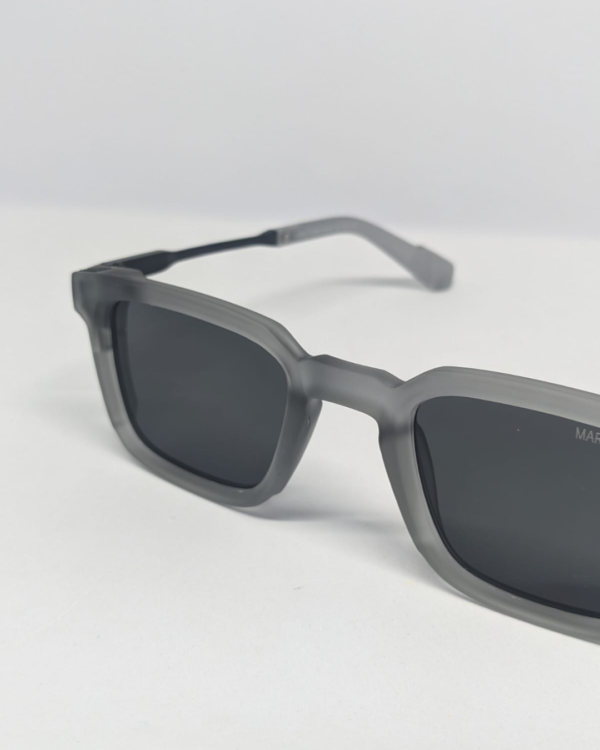 Close-up of matte frosted grey texture on square sunglasses frame