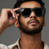 Model wearing matte black square sunglasses, casual outdoor look