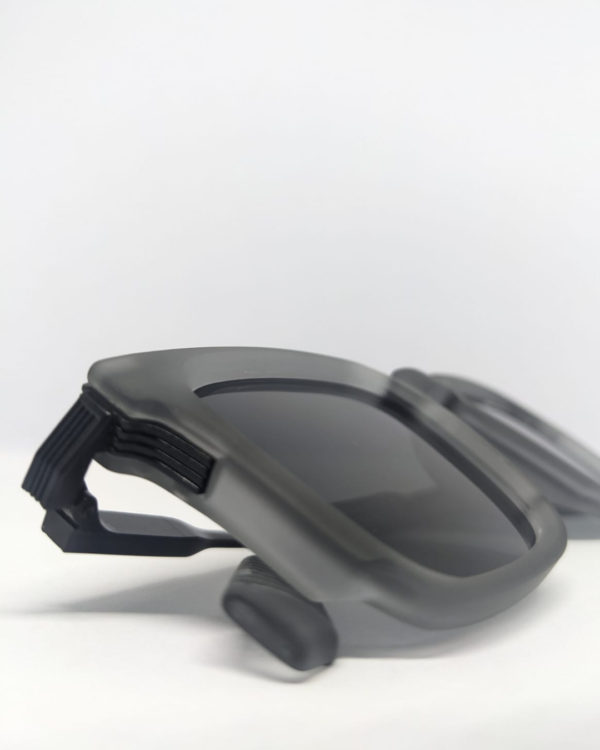 Close-up of dark charcoal lens on square matte grey sunglasses
