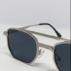 Close-up of dark smoke gray tinted lens on silver aviator sunglasses