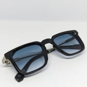 Square frame acetate sunglasses with blue gradient lens folded flat lay